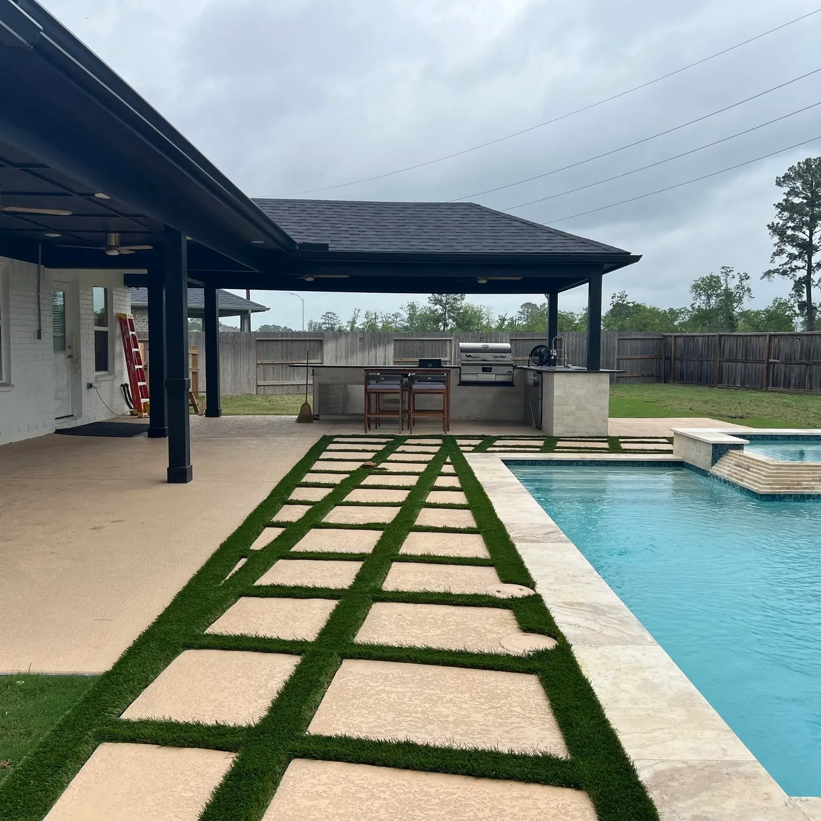 Paver and travertine hardscaping with turf