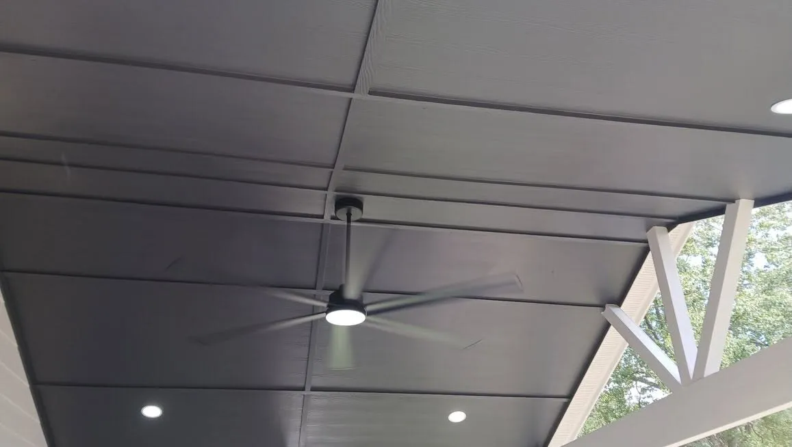 Patio cover with dark ceiling and large fan